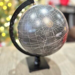 This is a contemporary black and silver-tone aluminum and PVC globe on a stand.